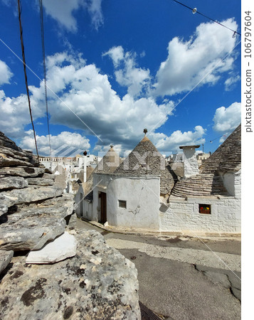 Alberobello, Apulia, Italy. Trulli in Alberobello are cylindrical structures with a cone-shaped roof, built using the dry masonry method. 106797604