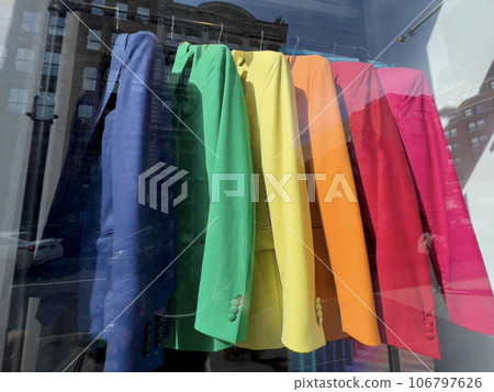 colorful clothes on hangers in window display of a store colorful clothes on hangers in window display of a store 106797626