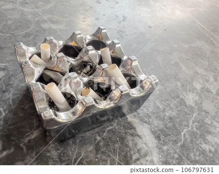 cigarette butts in ashtray on table cigarette butts in ashtray on table 106797631