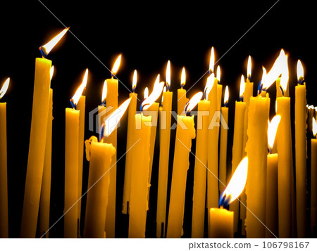 yellow burning candles isolated on black in church yellow burning candles isolated on black in church 106798167
