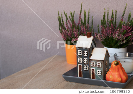 Cute autumn hygge home decor arrangement with pink heather and chrysanthemum flowers. Cute autumn hygge home decor arrangement with pink heather and chrysanthemum flowers. 106799520