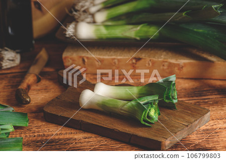 Fresh green leek on cutting board Fresh green leek on cutting board 106799803