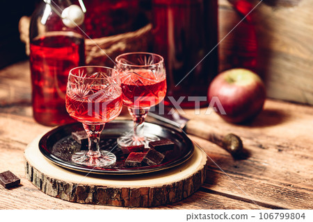 Homemade berry alcoholic beverage and chocolate Homemade berry alcoholic beverage and chocolate 106799804