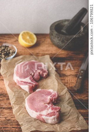 Two pork loin steaks with lemon and peppercorn Two pork loin steaks with lemon and peppercorn 106799821