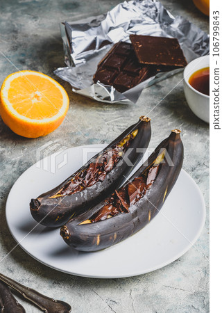 Grilled bananas with dark chocolate 106799843