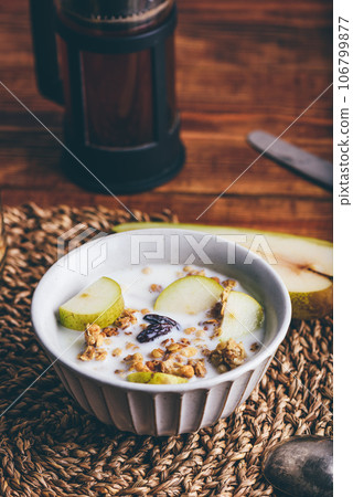 Delicious Granola with Pear and Raisins In Bowl 106799877