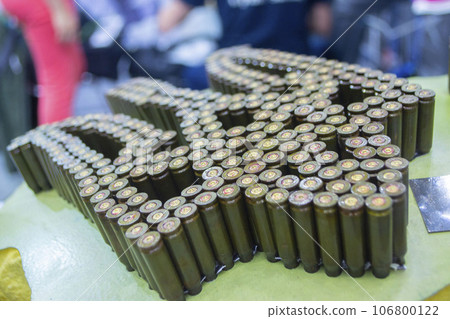 Emblem, coat of arms of Ukraine trident from used cartridges. Object made up of spent used cartridge cases. Lots used shells from cartridge cases ammo close up. Model from Many Used cartridge Cases. Emblem, coat of arms of Ukraine trident from used cartridges. Object made up of spent used cartridge cases. Lots used shells from cartridge cases ammo close up. Model from Many Used cartridge Cases. 106800122