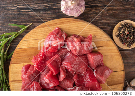 Close-up of goulash - pieces of beef or lamb meat on a cutting board. Close-up of goulash - pieces of beef or lamb meat on a cutting board. 106800278