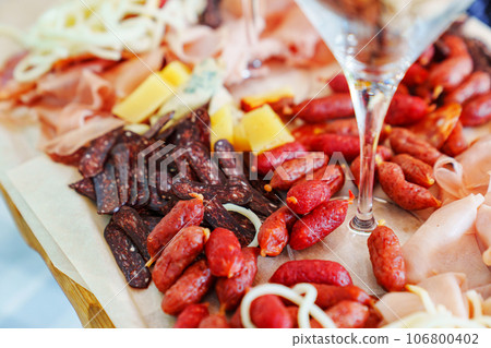 A tray with cheese and meat appetizers on the banquet table. A tray with cheese and meat appetizers on the banquet table. 106800402