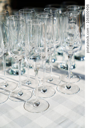 empty wine glasses on a table with a white tablecloth. 106800406