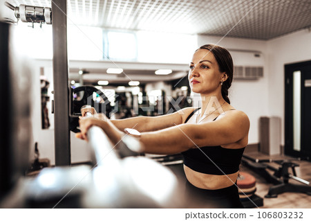 Portrait of a female personal trainer in a gym 106803232