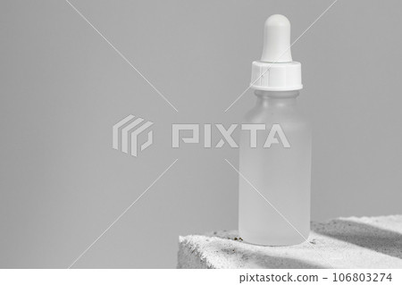 Glass jar of skincare serum on concrete block Glass jar of skincare serum on concrete block 106803274