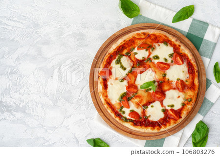 Top view of pizza Margherita on gray surface Top view of pizza Margherita on gray surface 106803276