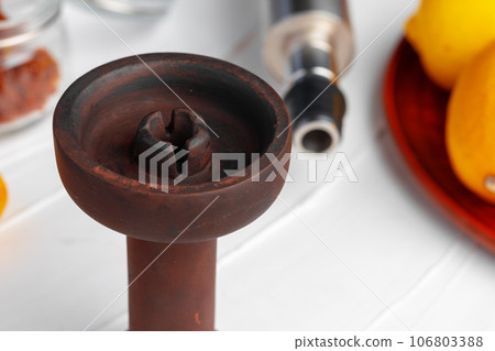 Empty hookah shaft close up on table with fresh fruit Empty hookah shaft close up on table with fresh fruit 106803388