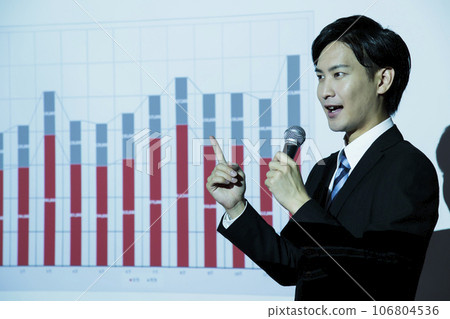 A young businessman giving a presentation using a projector at a meeting A young businessman giving a presentation using a projector at a meeting 106804536
