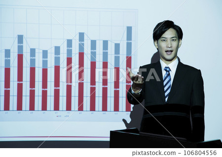A young businessman giving a presentation using a projector at a meeting A young businessman giving a presentation using a projector at a meeting 106804556