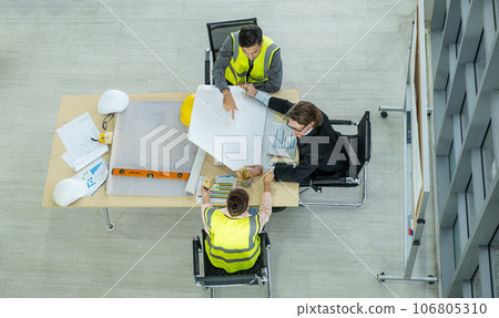Engineer team is meeting to inspect the construction blueprint drawings, work plan and distribute work before starting the building. 106805310