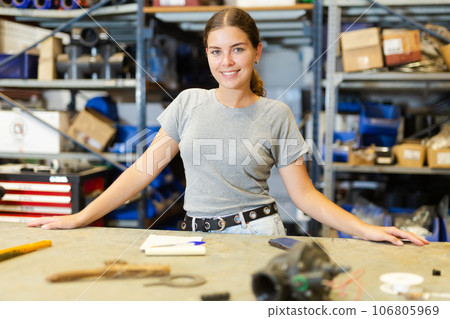 Young smiling girl posing at workplace Young smiling girl posing at workplace 106805969