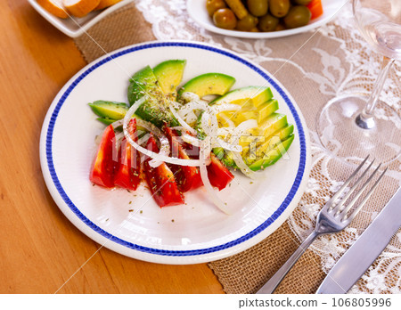 Salad from ripe avocado with tomatoes and onions Salad from ripe avocado with tomatoes and onions 106805996