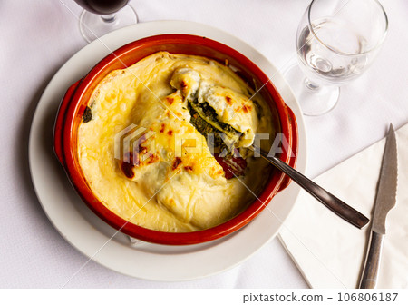 Traditional dish of Italian cuisine is spinach lasagna Traditional dish of Italian cuisine is spinach lasagna 106806187