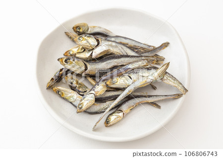 Dried sardines on a white plate, white background 106806743