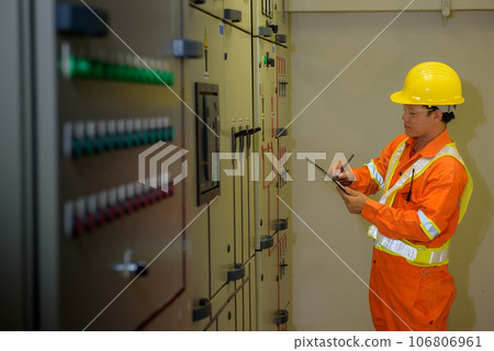 electrical engineer using tablet checking and service electrical engineer using tablet checking and service 106806961
