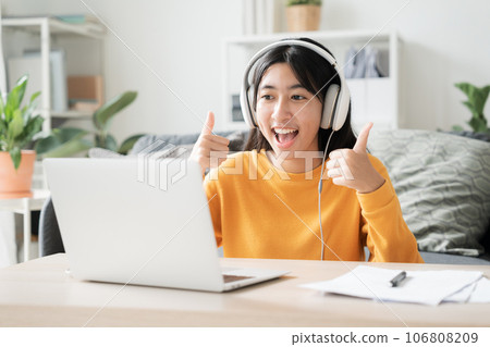 Homeschooling. Asian girl online learn video conference via internet with tutor on computer 106808209