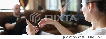 Female patient explains her relationship problem to psychologist while sitting in clinic's office. 106808575