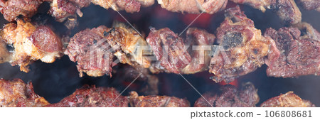 Top view of many metal skewers with meat in bbq grill. 106808681