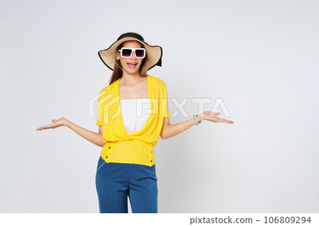Young woman wearing a sun hat and sunglasses, presenting or showing open hand palm with copy space for product isolated on white background. Young woman wearing a sun hat and sunglasses, presenting or showing open hand palm with copy space for product isolated on white background. 106809294