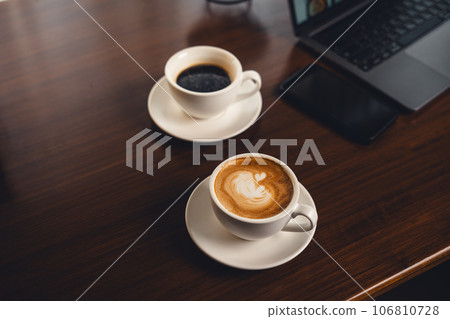 Coffee on the desk in the morning 106810728