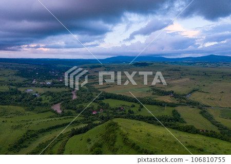 Aerial view of a storm and clouds above a village 106810755
