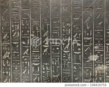 Egyptian hieroglyphs carved in stone background 106810758