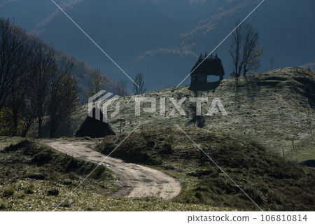 Autumn countryside landscape with wooden houses, thatched roof Autumn countryside landscape with wooden houses, thatched roof 106810814
