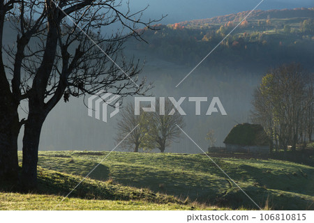 Autumn countryside landscape with wooden houses, thatched roof 106810815