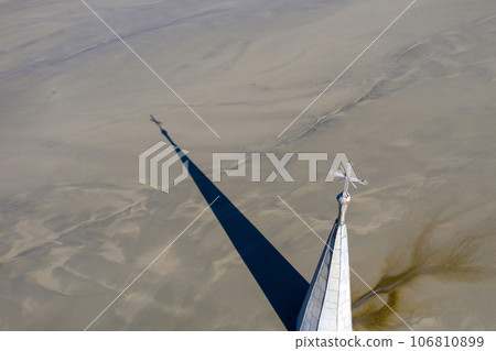Abstract aerial view of church tower with cross and shadow, flooded by copper mining residuals and mud 106810899
