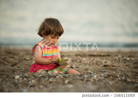 Toddler baby playing on a beach Toddler baby playing on a beach 106811089