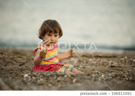 Toddler baby playing on a beach Toddler baby playing on a beach 106811091