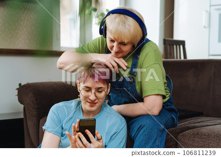Daughter with smartphone teaching senior mother cyber security, online shopping Daughter with smartphone teaching senior mother cyber security, online shopping 106811239