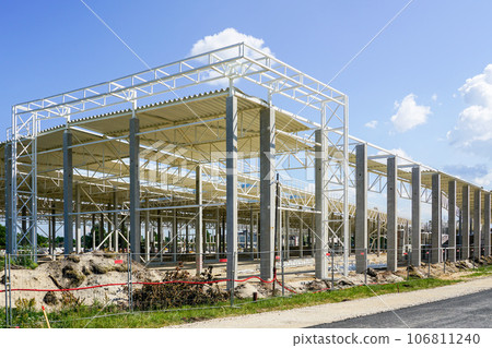 Unfinished warehouse steel frame structure on reinforced concrete supports, corrugated steel roof Unfinished warehouse steel frame structure on reinforced concrete supports, corrugated steel roof 106811240