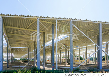 New large building steel framework with corrugated steel roof on reinforced concrete supports New large building steel framework with corrugated steel roof on reinforced concrete supports 106811242