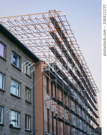 High scaffold for temporary roof being erected around a building to re-roof to be carried out High scaffold for temporary roof being erected around a building to re-roof to be carried out 106811255