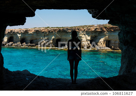 Sexy blonde woman posing in a sea cave 106811627