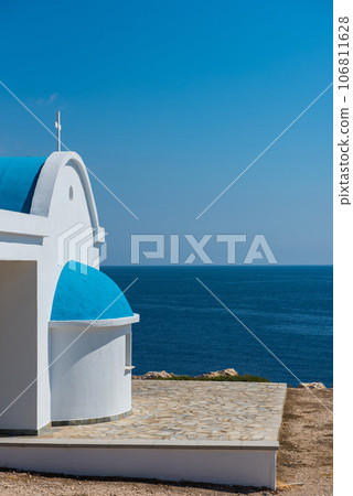 Traditional white chapel with a blue roof on the seaside. Agioi Anargyroi, Cyprus 106811628