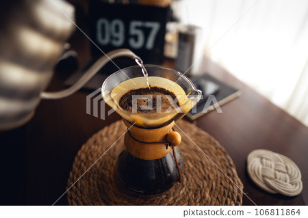 Drip coffee,Pouring water into filter coffee maker 106811864