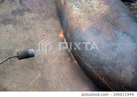 Slaughter burn the pig hair off with a gas burner Slaughter burn the pig hair off with a gas burner 106811949