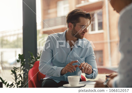Two business colleagues working together on project sitting in modern office near window 106812057