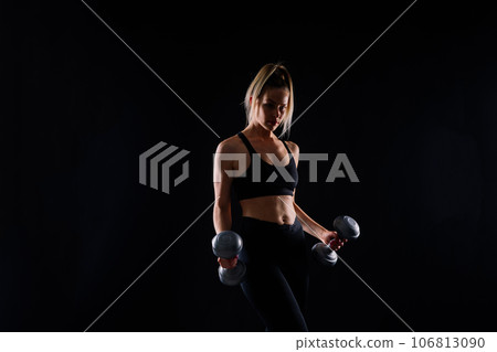 Perfect sporty female working out with dumbbells. Photo of woman in sportswear, studio Perfect sporty female working out with dumbbells. Photo of woman in sportswear, studio 106813090