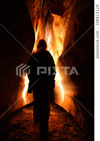 Spelunker exploring a cave 106813129