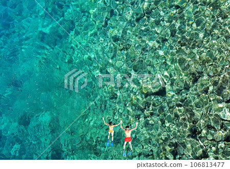 Couple snorkeling in the sea, aerial view 106813477